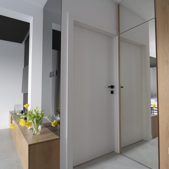 Realizacja MiD Meble w Warszawie: nowoczesne meble na wymiar – kuchnia, zabudowa RTV, konsola, ściana lustrzana i fornirowane detale. MiD Prestige