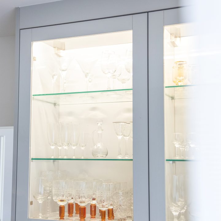 Nowoczesna kuchnia na wymiar w Słupsku – wyspa, wysoka zabudowa i szafki w dwóch głębokościach. Fronty akrylowe w szarym połysku i perfekcyjne dopasowanie. MiD Meble. MiD Faast Fit.