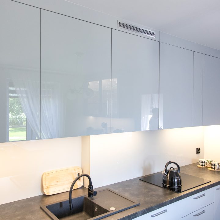 Nowoczesna kuchnia na wymiar w Słupsku – wyspa, wysoka zabudowa i szafki w dwóch głębokościach. Fronty akrylowe w szarym połysku i perfekcyjne dopasowanie. MiD Meble. MiD Faast Fit.