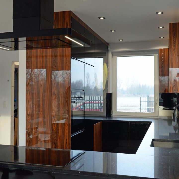 Kuchnia na wymiar w Łomiankach – czarny połysk, fornir palisandrowy i blat z kamienia. Elegancja, jakość i styl w pakiecie MiD Prestige.